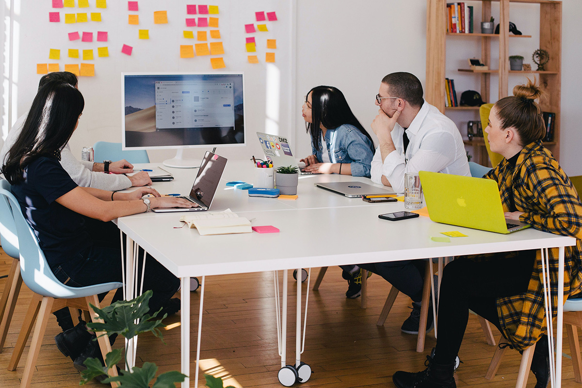 Employees planning work on whiteboard